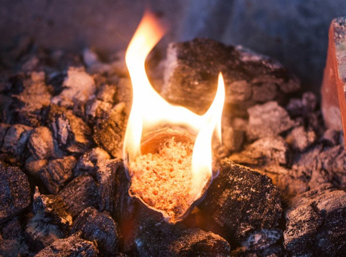 Close-up of a STOKES firestarter burning